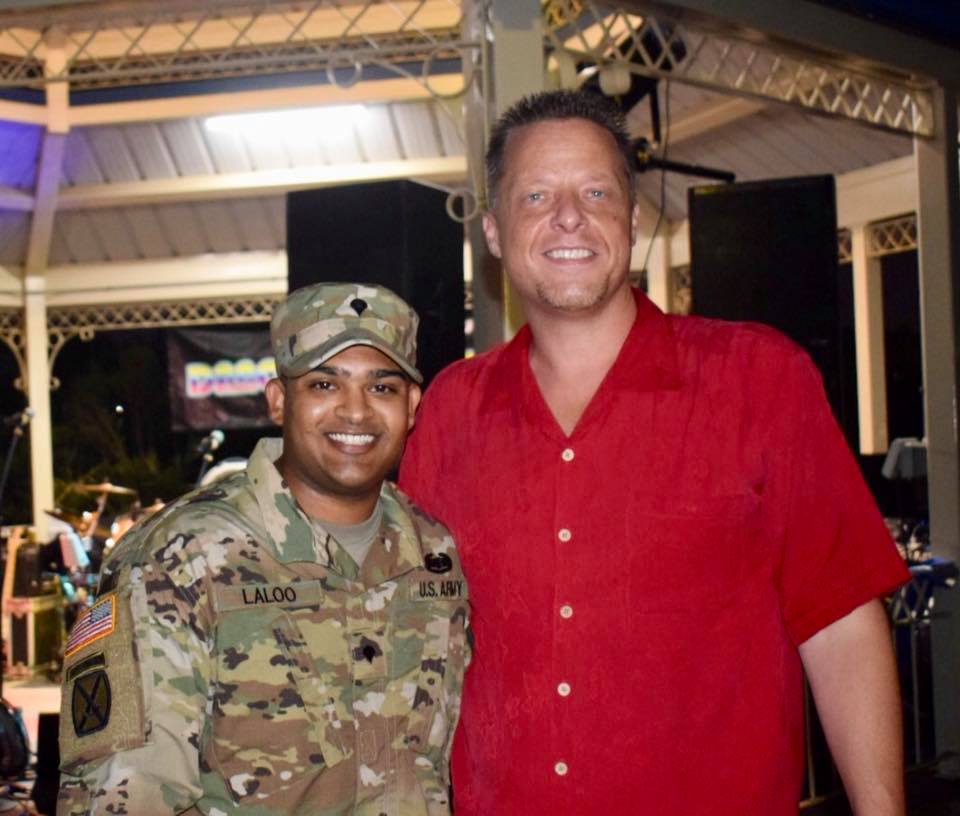A man and a soldier posing for the camera.